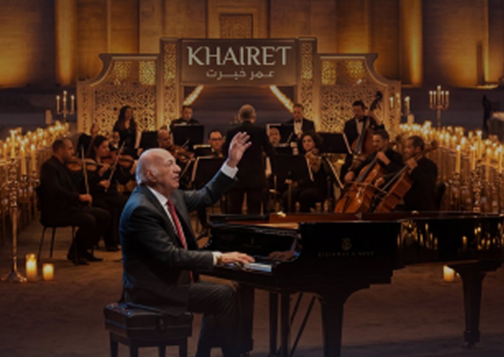 Omar Khairat at the piano with the orchestra, candle-lit, at The Capital Opera House